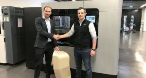 André Bialoscek Head of Vehicle Physical Integration Hennigsdorf, Bombardier, holding a 3D printed Air Duct, and Dominik Mueller, Strategic Account Manager at Stratasys